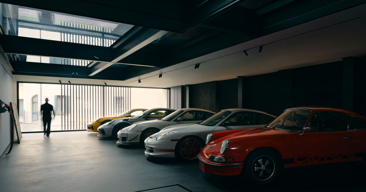 black resin, glass, and steel shape alessandro isola's automotive sanctuary in italy