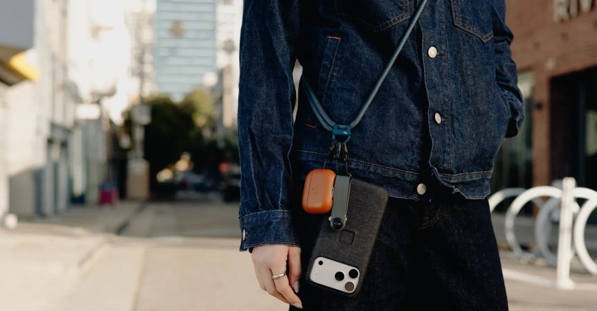 A word with a woman trying to pull off a crossbody phone strap