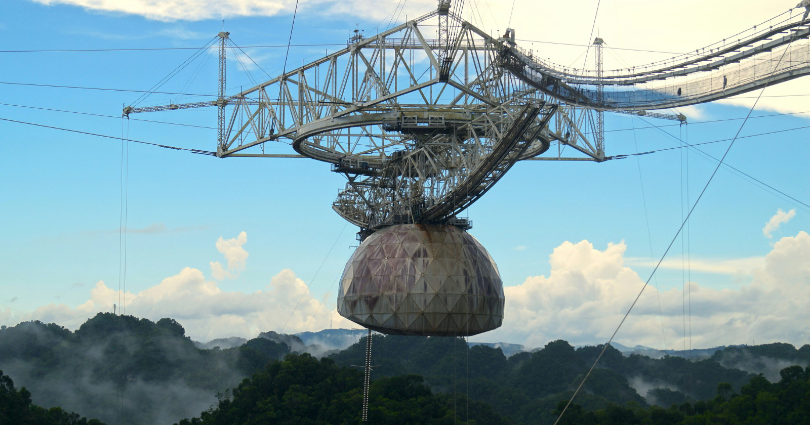 For 57 years, the Arecibo Observatory’s 1,000-foot dish sat sunk into a Puerto Rican valley listening to the sky, and in December 2020, after cables holding its 900-ton instrument platform snapped one by one, the entire structure gave way and crashed straight through the reflector below.