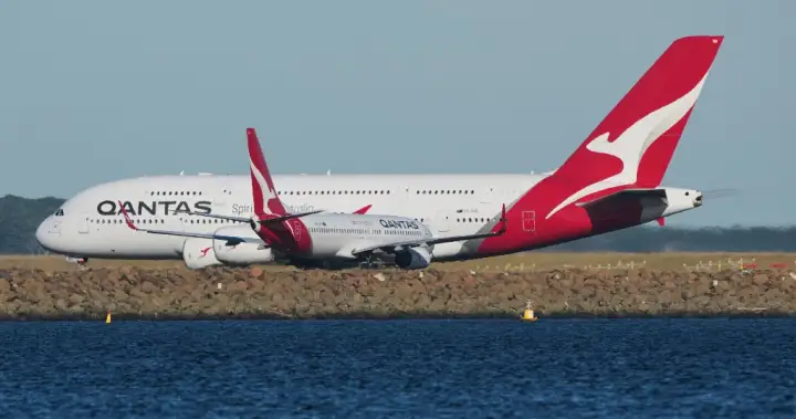 Man charged after allegedly trying to open Qantas plane door mid-flight - National