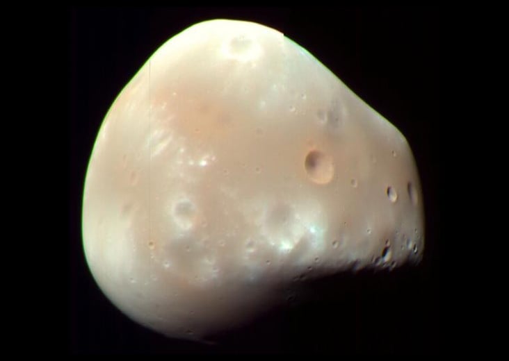 On Deimos, orbital speed just above the surface is only about 14 km/h—around elite racewalking pace—while roughly 20 km/h would let you escape the tiny moon altogether.