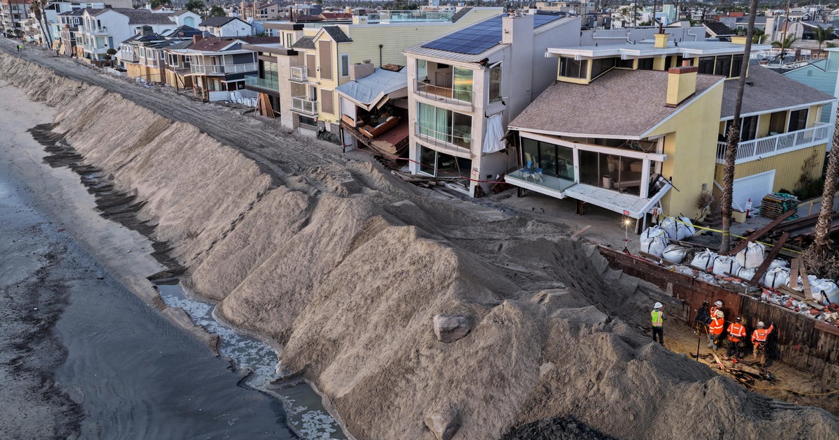 Photos show record-breaking high tides flooding homes, roads in Southern California